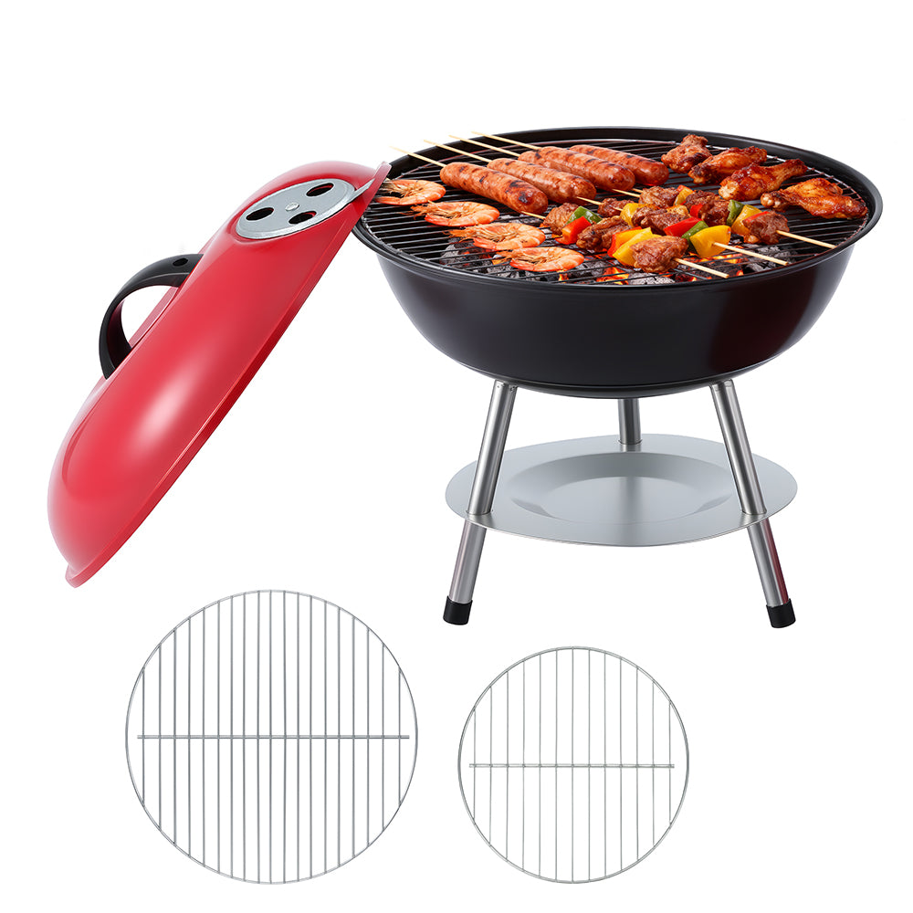Black portable grill with red handle and food on a white background